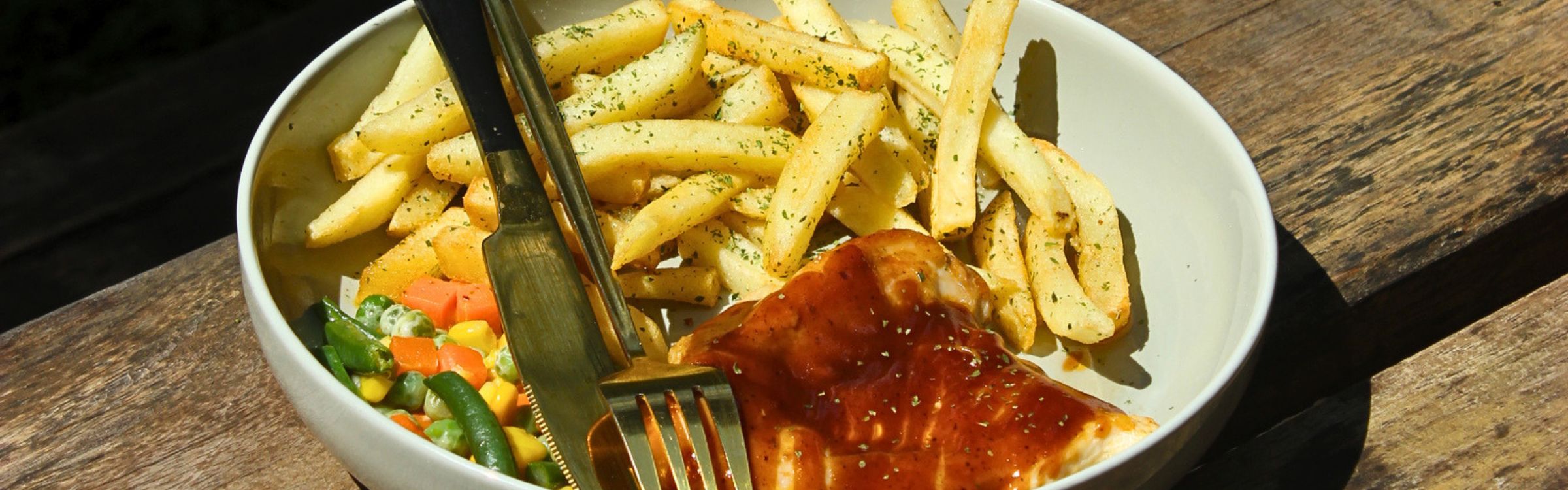 Rustic outdoor dining table with lush greenery